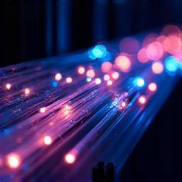 Fiber optic cables glowing, representing advanced fiber technology.